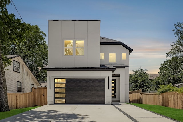 3105 Rutz St, Dallas, TX 75212 - contemporary house featuring concrete driveway, an attached garage, and board and batten siding