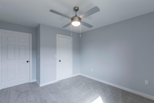 unfurnished bedroom with ceiling fan and carpet flooring