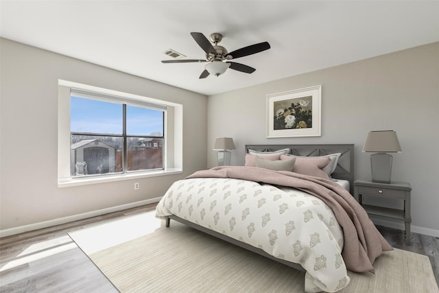bedroom with ceiling fan and hardwood / wood-style floors