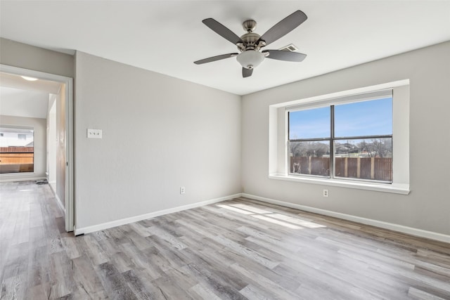 empty room featuring ceiling fan and light wood-type flooring