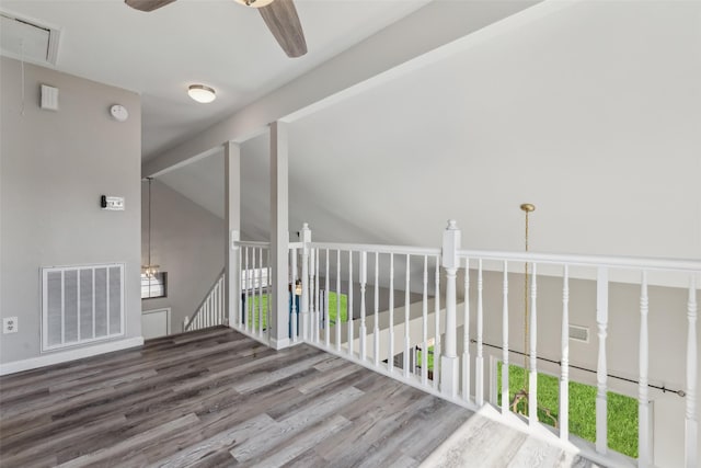 empty room featuring lofted ceiling, hardwood / wood-style flooring, and ceiling fan