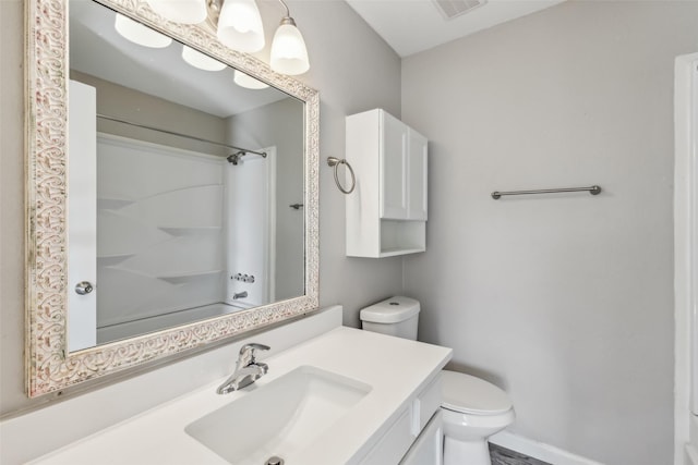 bathroom featuring a shower, vanity, and toilet