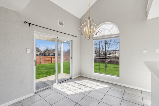 unfurnished dining area featuring light tile patterned floors, a chandelier, high vaulted ceiling, and a wealth of natural light