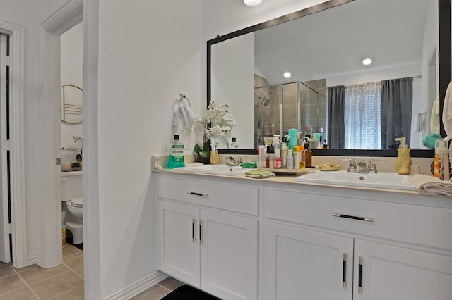 bathroom with tile patterned floors, toilet, an enclosed shower, and vanity