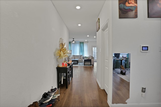 hallway with hardwood / wood-style flooring