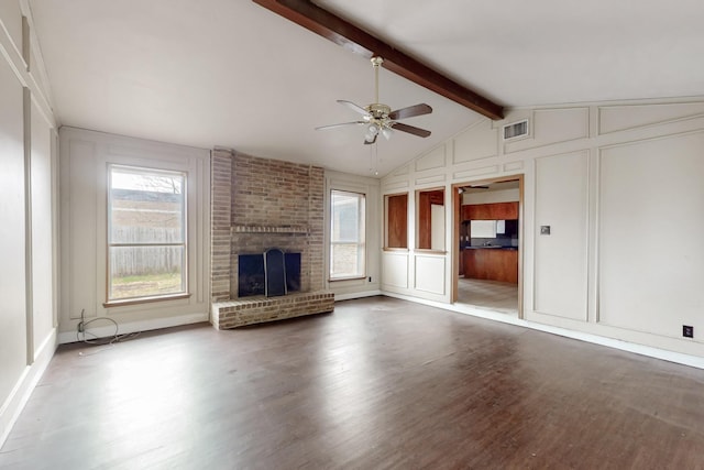 unfurnished living room featuring ceiling fan, vaulted ceiling with beams, dark wood-type flooring, and a fireplace