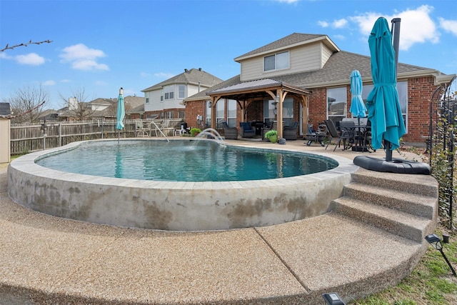 view of pool featuring a gazebo, a patio, fence, and a fenced in pool