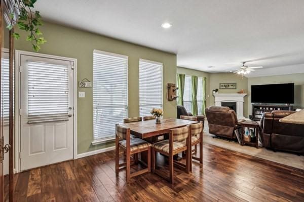 dining space with ceiling fan and dark hardwood / wood-style floors