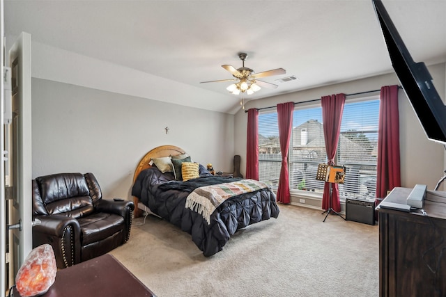 bedroom with ceiling fan, vaulted ceiling, and light carpet