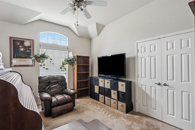 carpeted living room with vaulted ceiling and ceiling fan