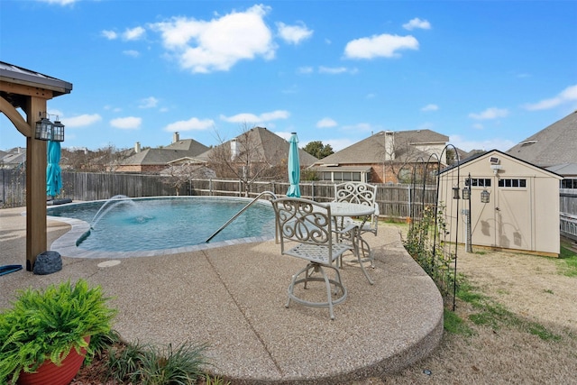 view of pool featuring a shed, a patio area, and pool water feature