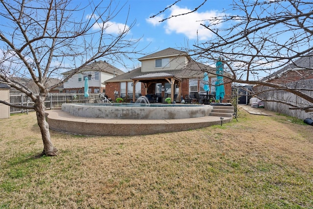 back of house with a gazebo and a yard