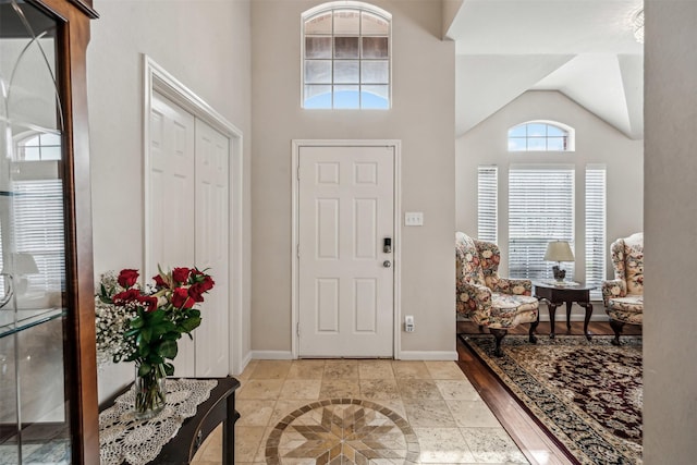 foyer with high vaulted ceiling