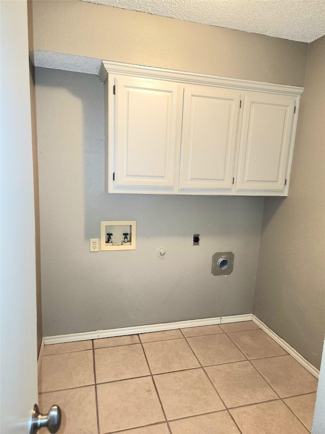 laundry room with electric dryer hookup, hookup for a gas dryer, hookup for a washing machine, and light tile patterned floors