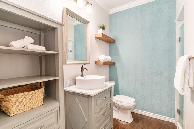 bathroom with vanity, hardwood / wood-style floors, ornamental molding, and toilet