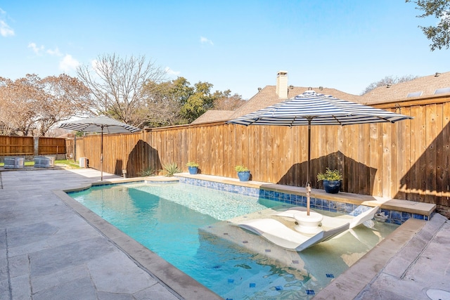 view of pool featuring a patio area and central air condition unit