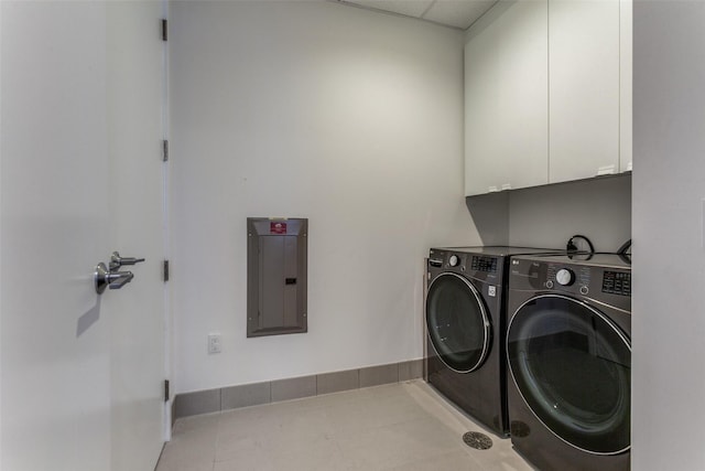 laundry room featuring cabinets, light tile patterned floors, electric panel, and independent washer and dryer