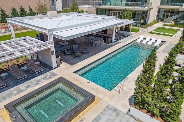 view of pool featuring a patio, a gazebo, an outdoor bar, and a community hot tub