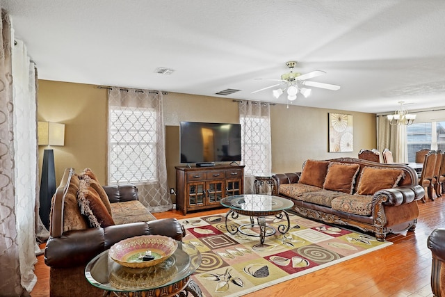 2312 Bantry Ln, Arlington, TX 76002 - living area with wood finished floors, ceiling fan, and a chandelier