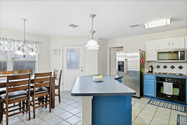 2312 Bantry Ln, Arlington, TX 76002 - kitchen featuring stainless steel appliances, light tile patterned floors, a chandelier, and backsplash