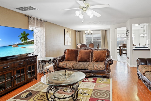 2312 Bantry Ln, Arlington, TX 76002 - living room with ceiling fan, hardwood / wood-style flooring, a chandelier, and baseboards