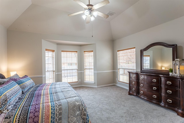 bedroom with light carpet, multiple windows, lofted ceiling, and ceiling fan