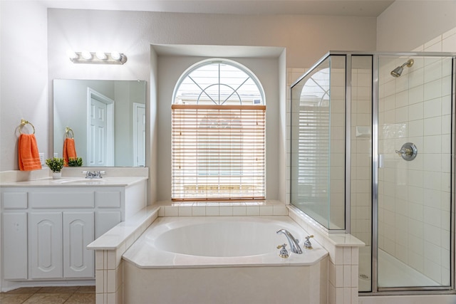 bathroom with tile patterned floors, vanity, shower with separate bathtub, and a wealth of natural light