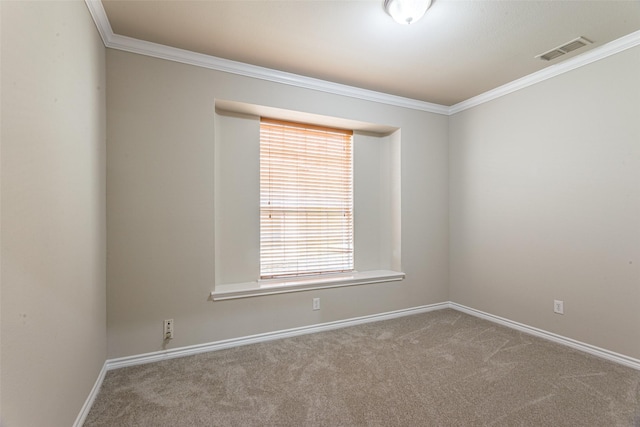 carpeted empty room featuring crown molding