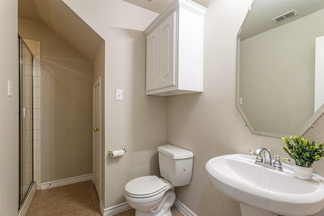 bathroom featuring walk in shower, tile patterned floors, toilet, and sink