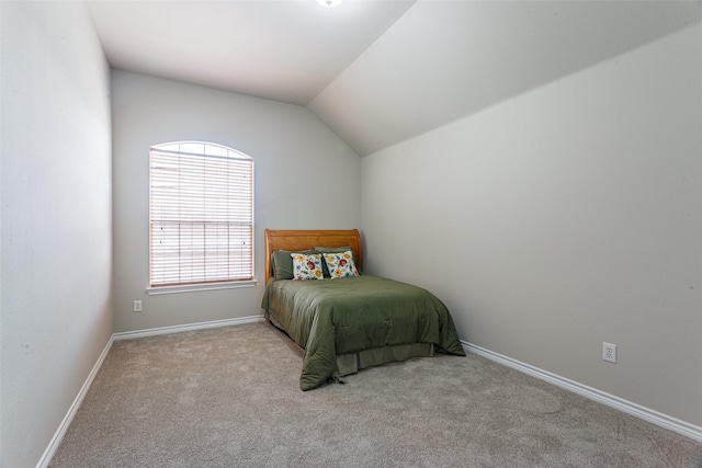 carpeted bedroom featuring vaulted ceiling