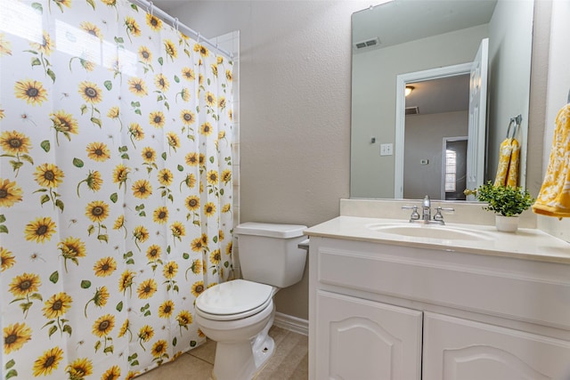 bathroom featuring tile patterned flooring, vanity, curtained shower, and toilet