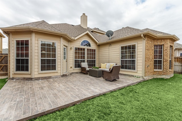 rear view of property with outdoor lounge area and a lawn