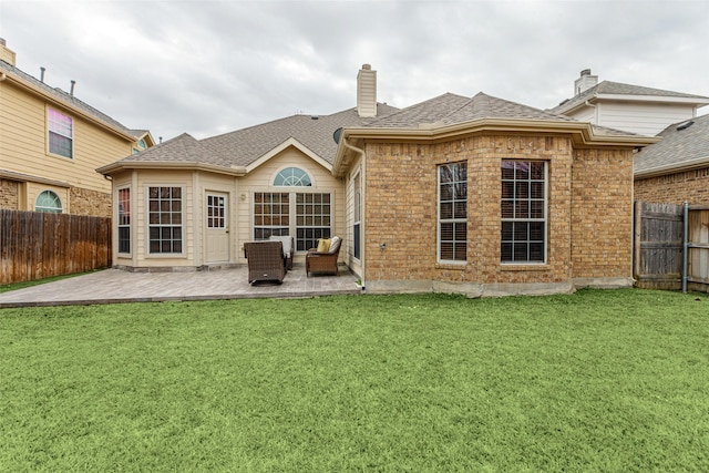 back of property featuring a yard and a patio area