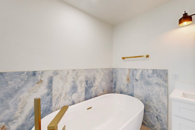 bathroom with vanity and a tub