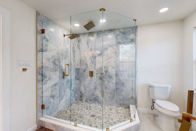 bathroom with toilet and an enclosed shower