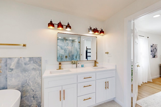 bathroom with vanity and a tub to relax in