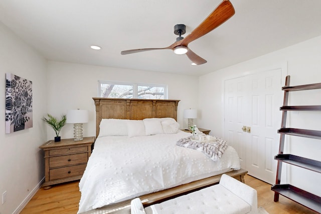 bedroom with ceiling fan and light hardwood / wood-style flooring