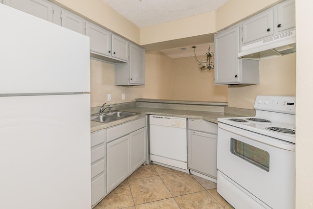 kitchen featuring white appliances, sink, a textured ceiling, and light tile patterned floors