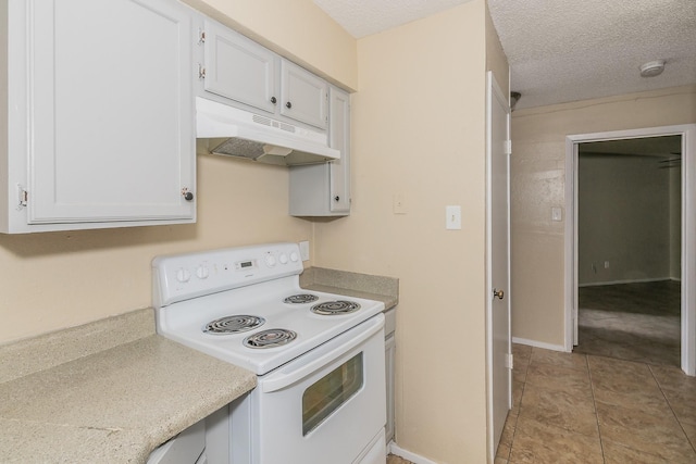 kitchen featuring light tile patterned floors, white cabinets, a textured ceiling, and electric stove