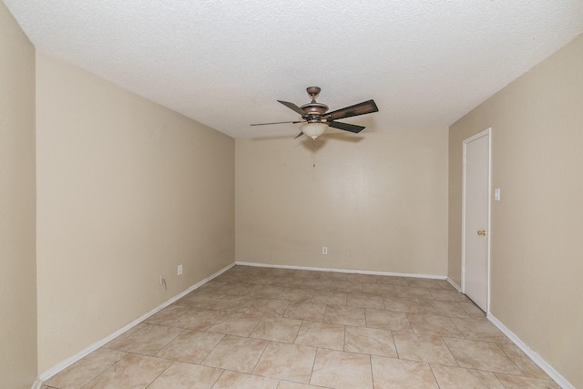 empty room with a textured ceiling and ceiling fan