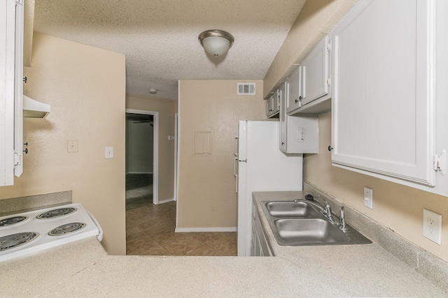 kitchen featuring electric range oven, range hood, white cabinetry, sink, and a textured ceiling