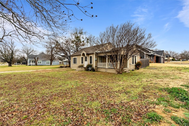 view of home's exterior with a porch and a yard