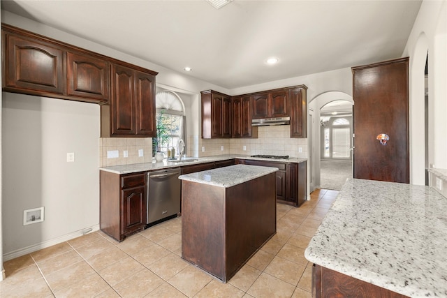 1300 Spanish Needle Trl, Fort Worth, TX 76177 - kitchen with arched walkways, a sink, stainless steel appliances, and tasteful backsplash