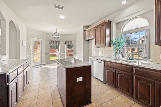 1300 Spanish Needle Trl, Fort Worth, TX 76177 - kitchen with light tile patterned flooring, visible vents, a kitchen island, a sink, and stainless steel dishwasher