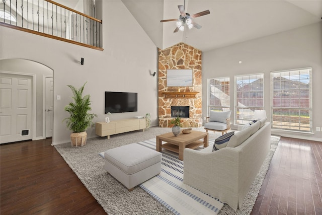 1300 Spanish Needle Trl, Fort Worth, TX 76177 - living room featuring high vaulted ceiling, hardwood / wood-style flooring, baseboards, a ceiling fan, and a stone fireplace