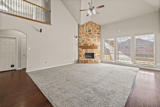 1300 Spanish Needle Trl, Fort Worth, TX 76177 - unfurnished living room featuring high vaulted ceiling, a ceiling fan, a stone fireplace, baseboards, and dark wood-style flooring