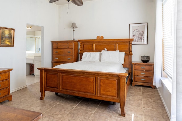 bedroom with a ceiling fan, connected bathroom, and light tile patterned flooring