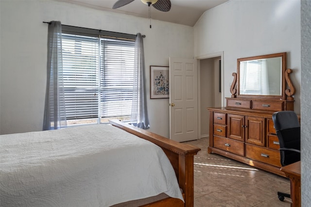 bedroom featuring vaulted ceiling, multiple windows, and a ceiling fan