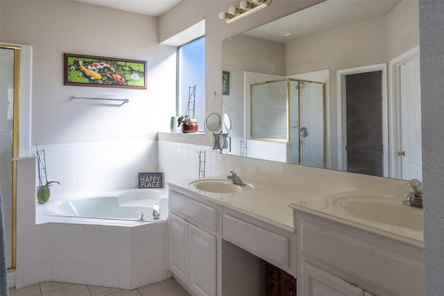 full bathroom with a stall shower, double vanity, a sink, and a bath