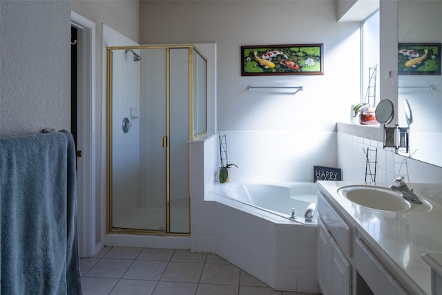 full bathroom featuring a stall shower, vanity, a garden tub, and tile patterned floors